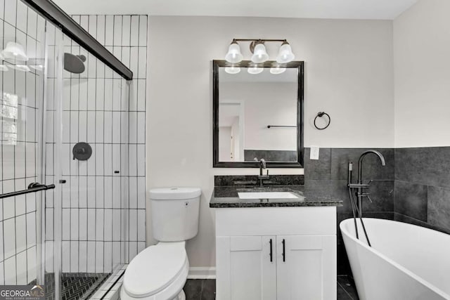 full bathroom featuring separate shower and tub, vanity, tile walls, and toilet