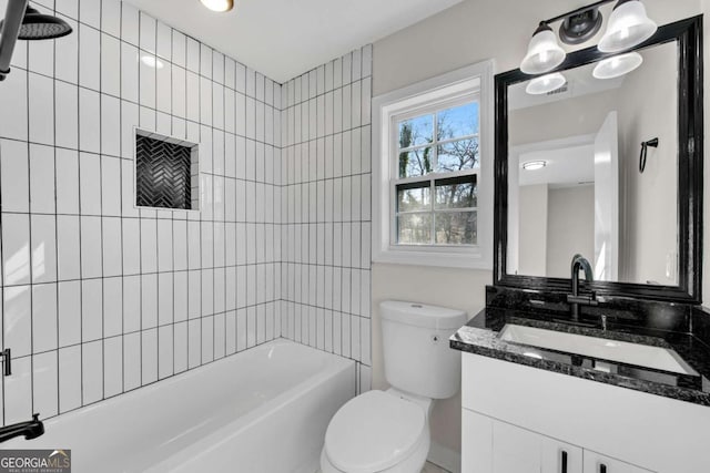 full bathroom featuring vanity, toilet, and tiled shower / bath combo