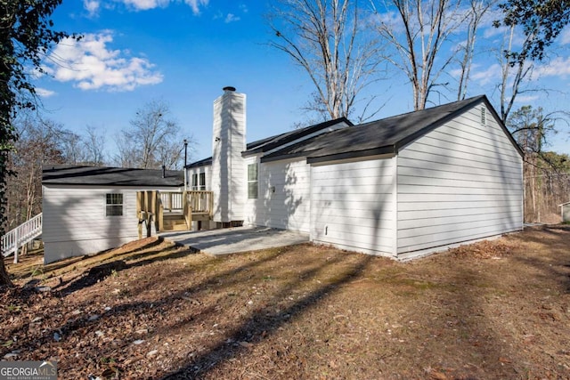 rear view of property featuring a yard and a patio