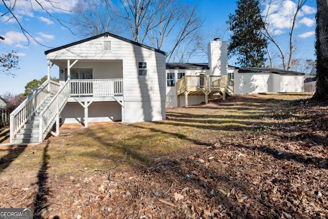 rear view of house featuring a lawn