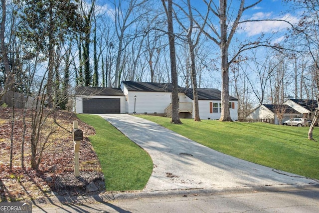 ranch-style house featuring a front yard and a garage