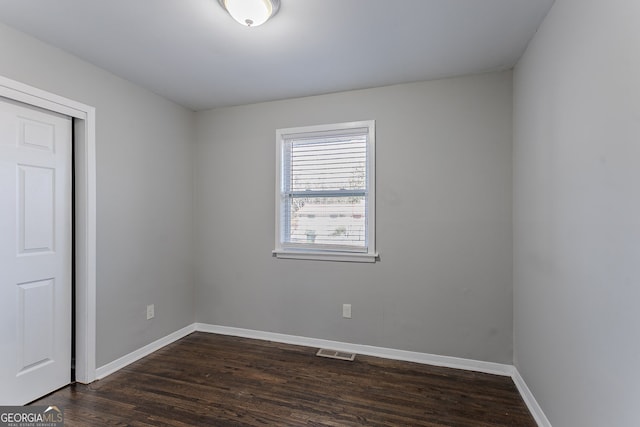 spare room with dark hardwood / wood-style floors