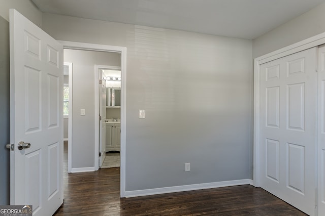 unfurnished bedroom featuring dark wood-type flooring