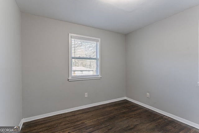 unfurnished room with dark hardwood / wood-style floors