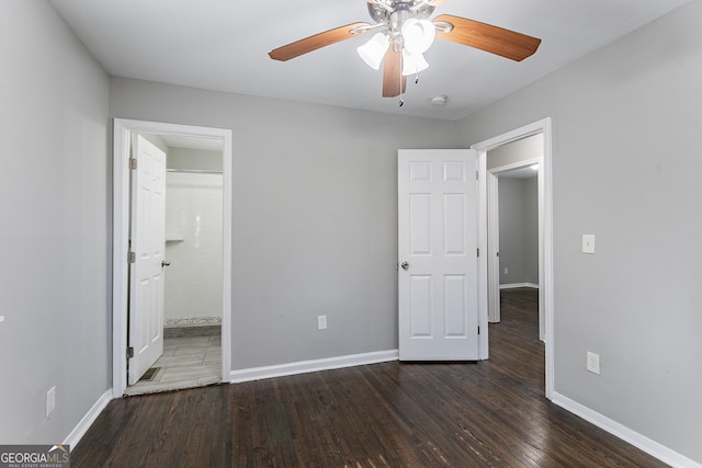 unfurnished bedroom with ensuite bathroom, ceiling fan, and dark hardwood / wood-style floors