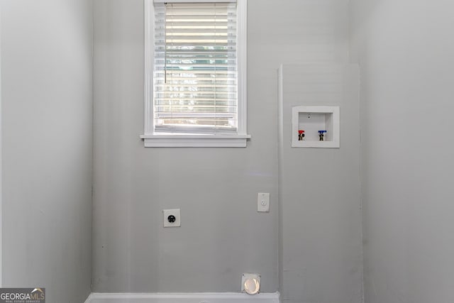 washroom featuring electric dryer hookup, washer hookup, and a wealth of natural light