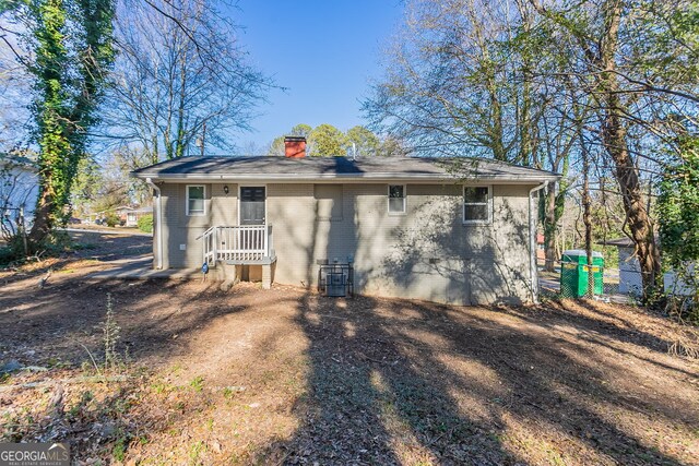 rear view of property with central air condition unit