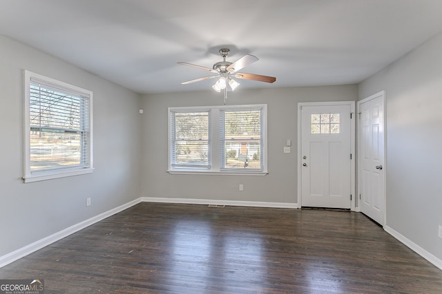 foyer entrance featuring ceiling fan and dark wood-type flooring