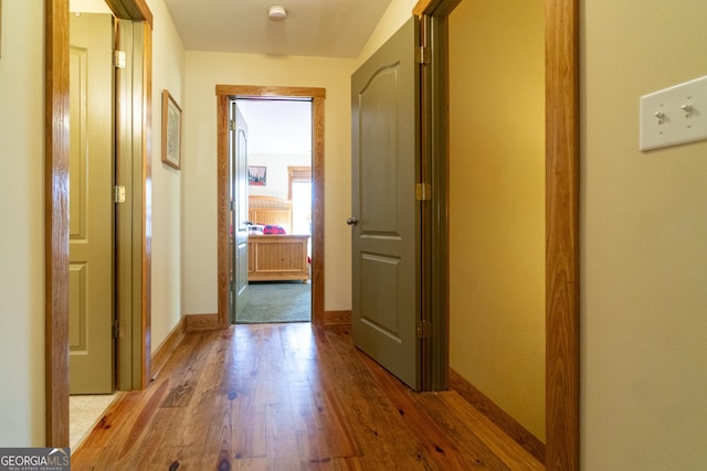 corridor with light hardwood / wood-style floors