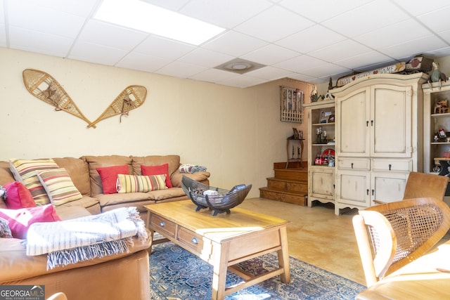 living room featuring a drop ceiling