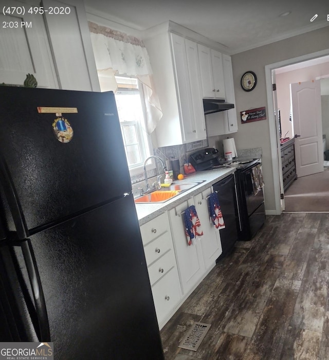 kitchen featuring black appliances, crown molding, sink, dark hardwood / wood-style floors, and white cabinetry