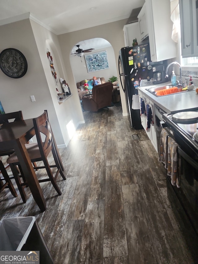 kitchen featuring black range with electric stovetop, white cabinetry, sink, and dark hardwood / wood-style flooring