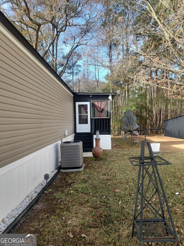 view of yard featuring a sunroom and cooling unit