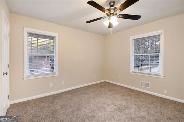 carpeted empty room featuring ceiling fan