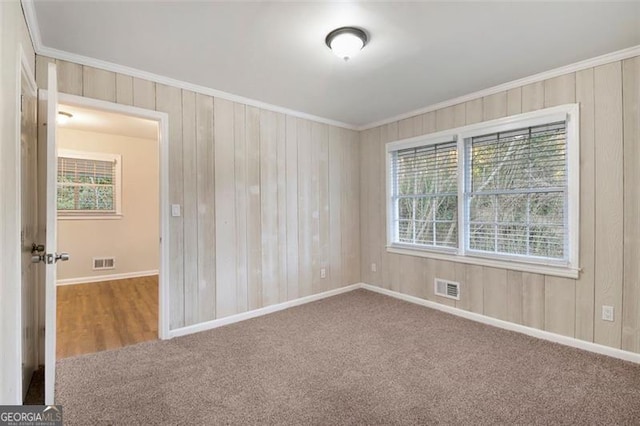 carpeted spare room with ornamental molding