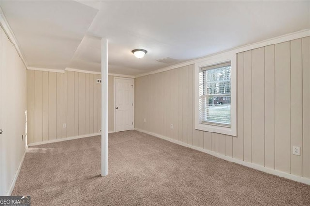 basement with light colored carpet and ornamental molding