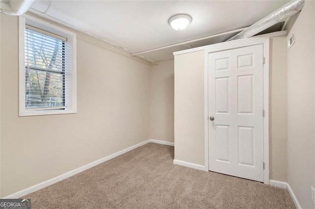 basement featuring light colored carpet