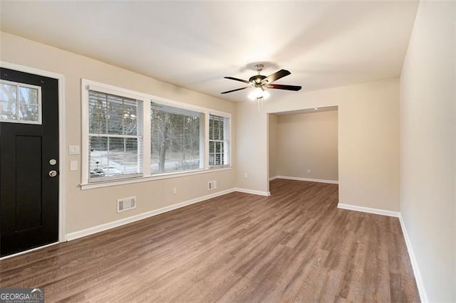 foyer entrance with ceiling fan and wood-type flooring