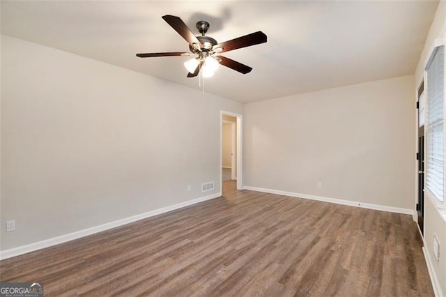 spare room with ceiling fan and wood-type flooring