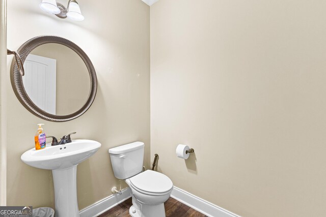 bathroom featuring hardwood / wood-style floors, toilet, and sink