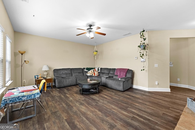 living room featuring ceiling fan and dark hardwood / wood-style flooring