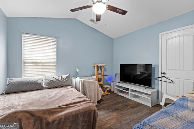 bedroom featuring ceiling fan, dark wood-type flooring, and vaulted ceiling