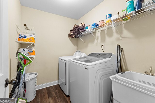 laundry room featuring dark hardwood / wood-style floors, separate washer and dryer, and sink