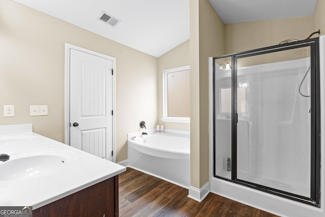 bathroom with vanity, hardwood / wood-style flooring, separate shower and tub, and lofted ceiling