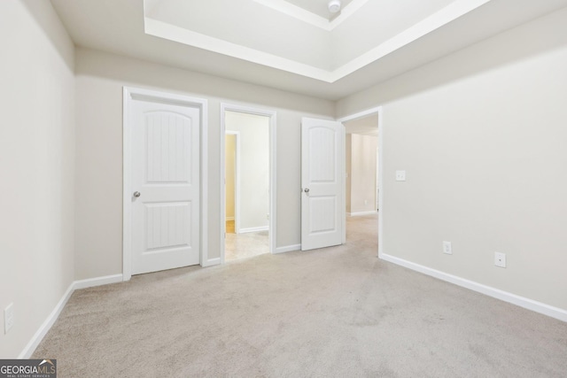 unfurnished bedroom featuring light carpet