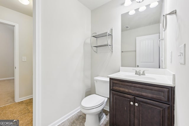 bathroom featuring tile patterned floors, vanity, and toilet