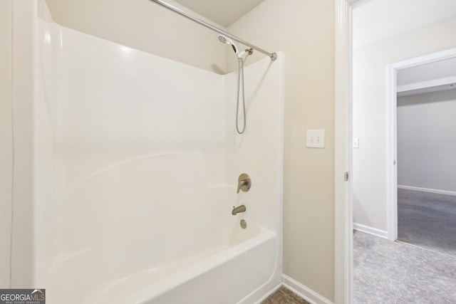 bathroom with tile patterned floors and bathtub / shower combination