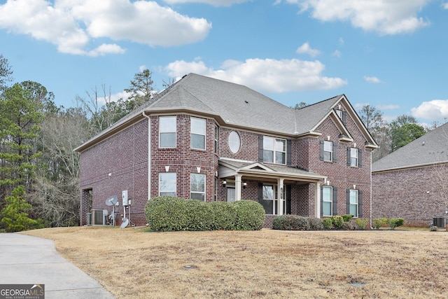 view of front of property with cooling unit and a front lawn