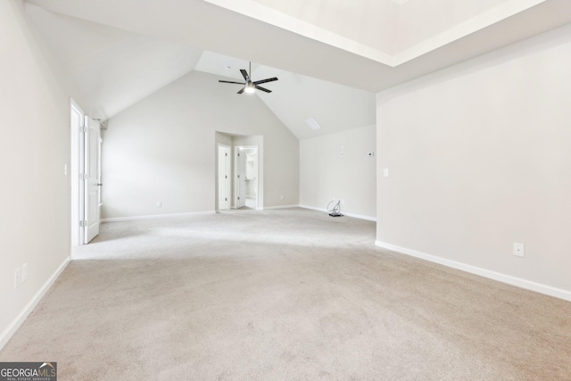 empty room with light carpet, ceiling fan, and lofted ceiling