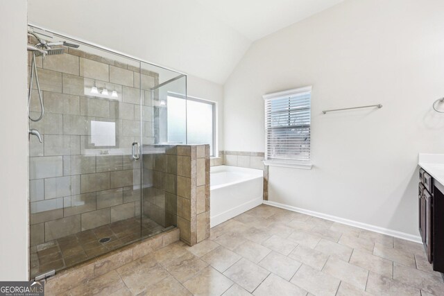 bathroom with vanity, vaulted ceiling, and independent shower and bath