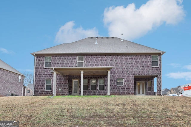 rear view of property featuring a yard