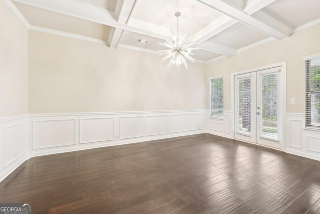 unfurnished room with beamed ceiling, french doors, dark wood-type flooring, and an inviting chandelier