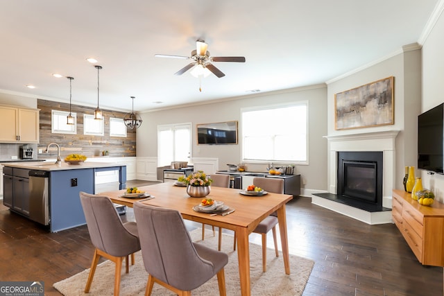 dining area with crown molding, sink, ceiling fan, and dark hardwood / wood-style floors