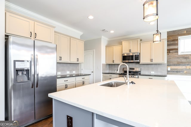 kitchen with appliances with stainless steel finishes, hanging light fixtures, crown molding, and cream cabinets