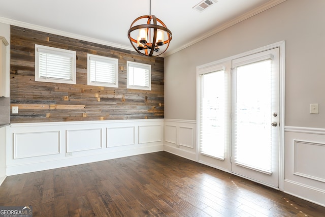 unfurnished dining area with a wealth of natural light, dark wood-type flooring, and an inviting chandelier