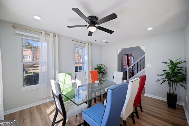 dining space with dark hardwood / wood-style flooring and ceiling fan