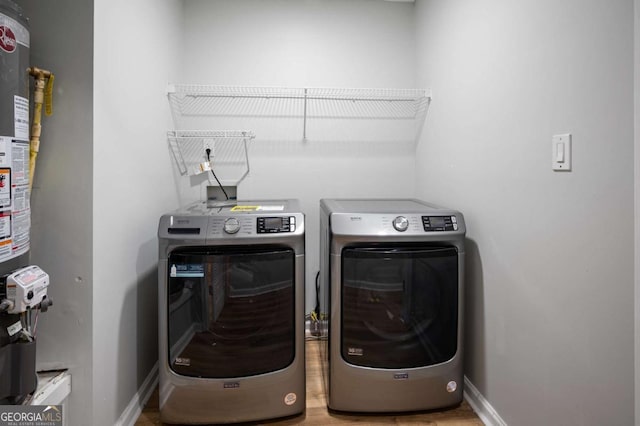 clothes washing area with washer and clothes dryer