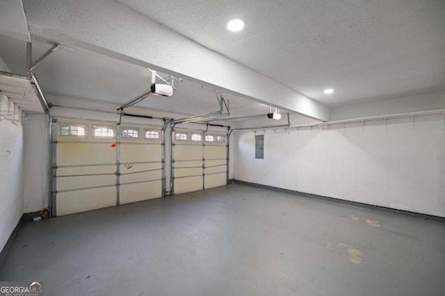 garage with electric panel and a garage door opener