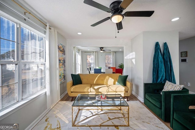 living room featuring light hardwood / wood-style flooring and ceiling fan