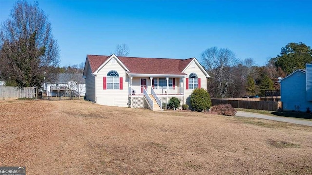 view of front of house with covered porch and a front yard