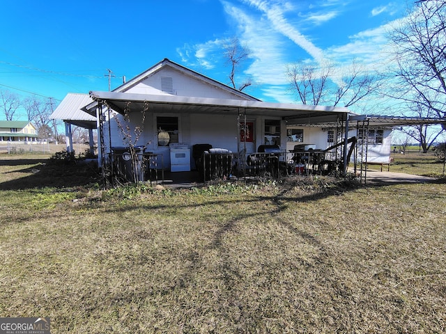 rear view of house featuring a lawn