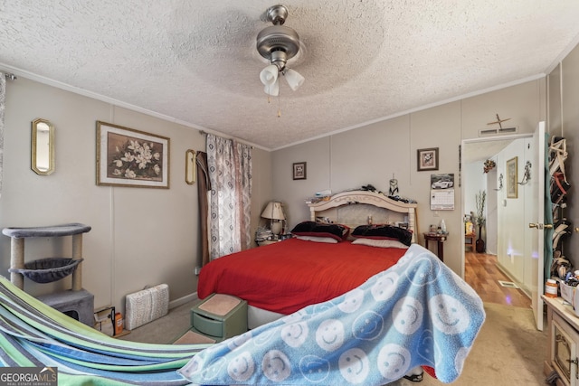 bedroom featuring crown molding, ceiling fan, light colored carpet, and a textured ceiling