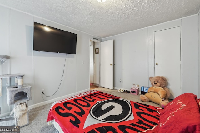 bedroom with light carpet and a textured ceiling