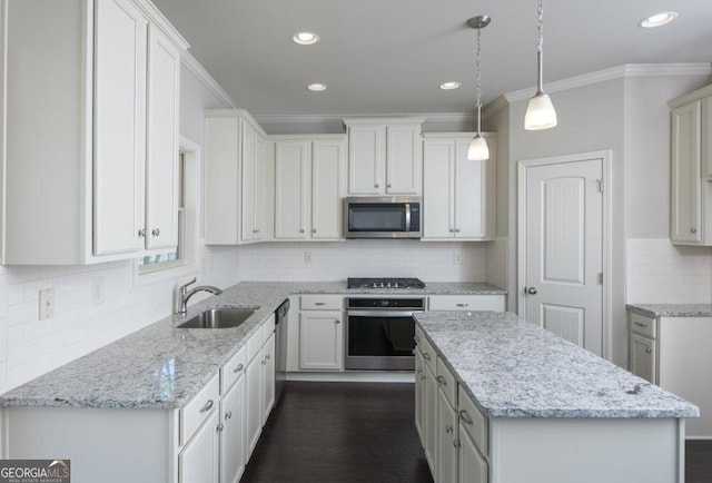 kitchen featuring sink, white cabinetry, light stone counters, hanging light fixtures, and appliances with stainless steel finishes