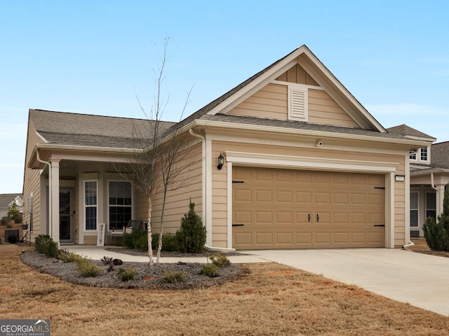 ranch-style house featuring central air condition unit, a porch, and a garage