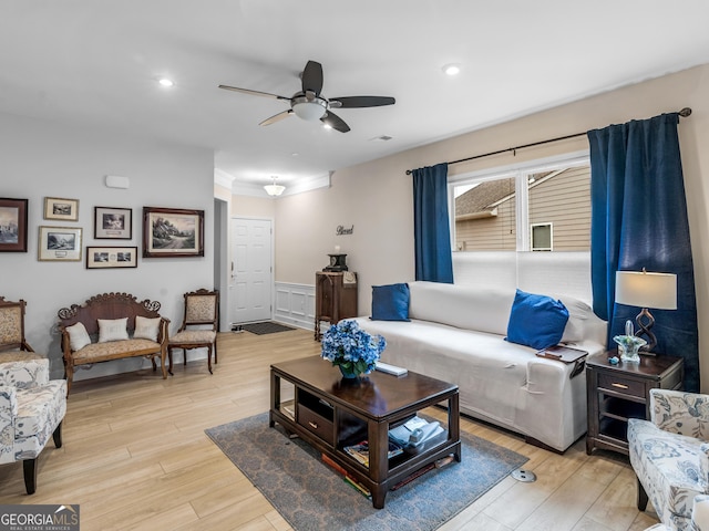 living room featuring ceiling fan and light hardwood / wood-style flooring